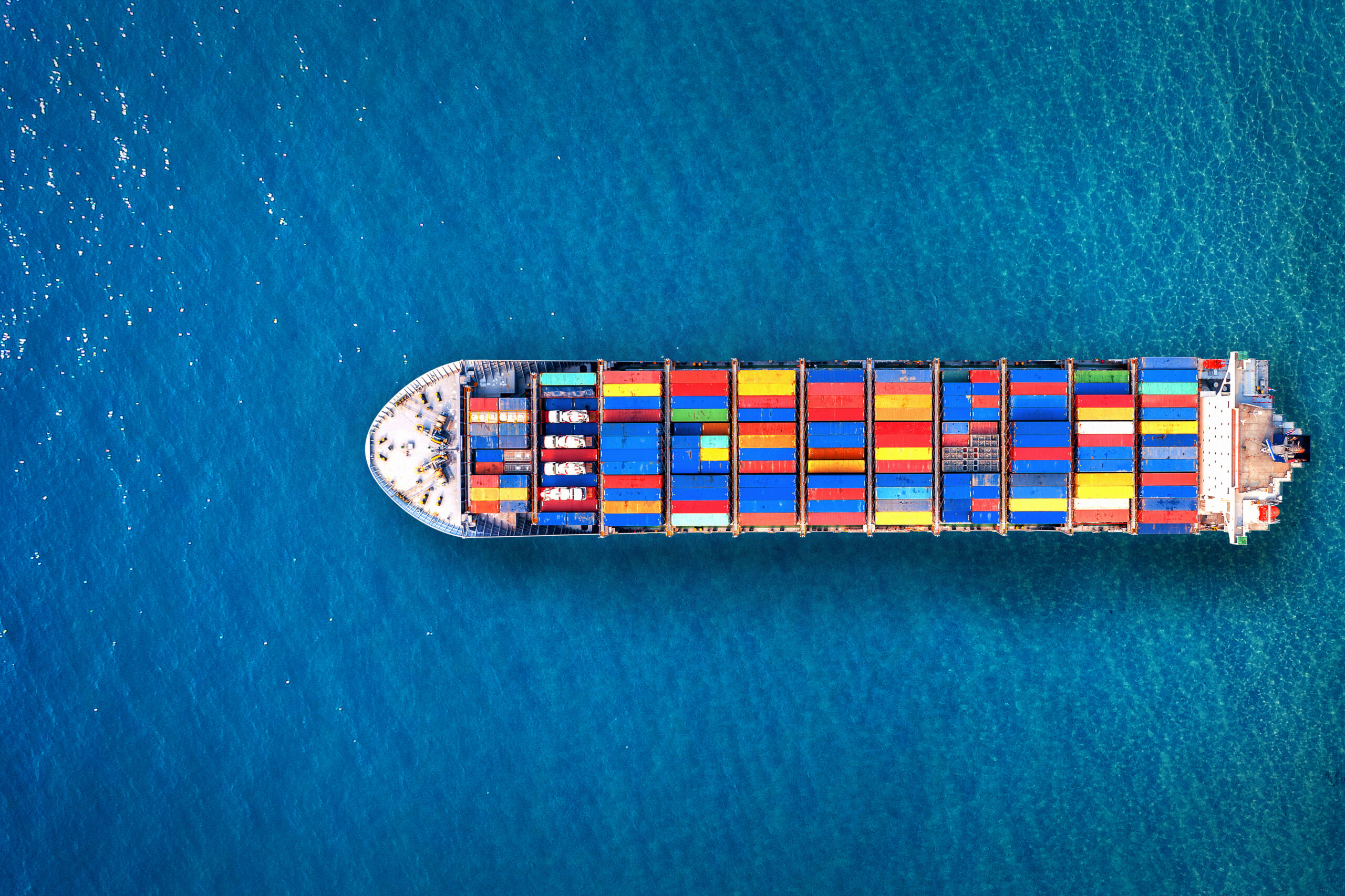 Home aerial view of container cargo ship in sea.